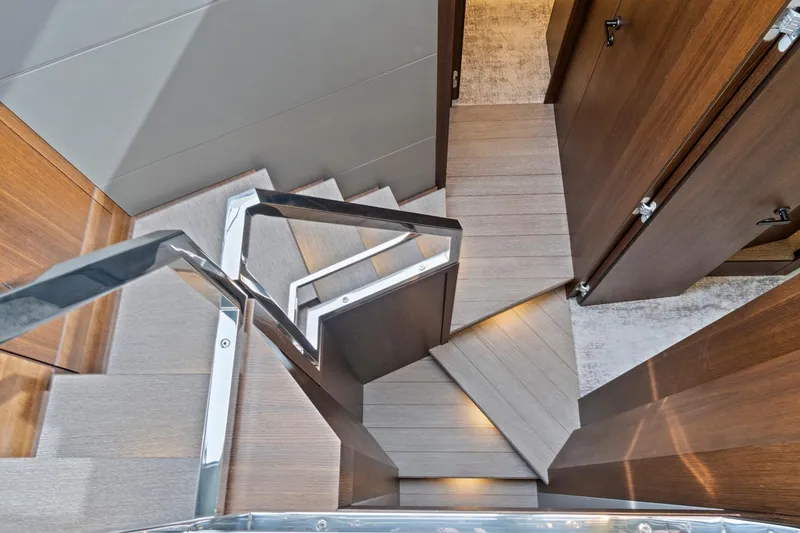 Slide: The Image of Luxurious wooden staircase with ambient lighting on the 2022 Astondoa 66 Flybridge yacht. - 37