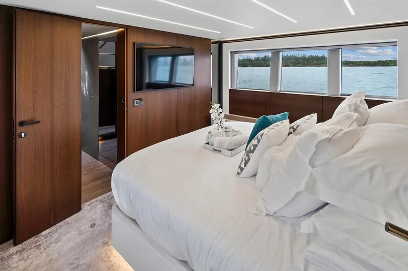 Slide: The Image of Luxurious bedroom interior of 2022 Astondoa 66 Flybridge yacht with elegant wood finishes. - 40