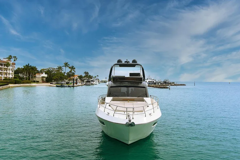 Slide: The Image of 2022 Astondoa 66 Flybridge yacht on serene water under blue sky. - 5