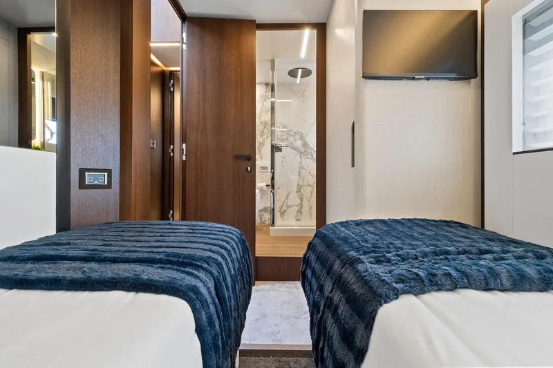 Slide: The Image of Luxurious twin bedroom on 2022 Astondoa 66 Flybridge yacht with modern decor and ensuite bathroom. - 55
