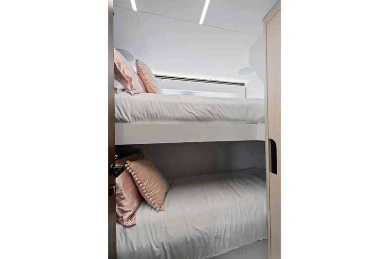 Slide: The Image of Bunk beds in 2022 Astondoa 66 Flybridge yacht cabin with elegant decor. - 56