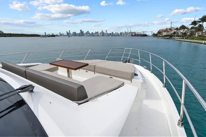 Slide: The Image of 2022 Astondoa 66 Flybridge yacht cruising near luxury waterfront homes. - 8