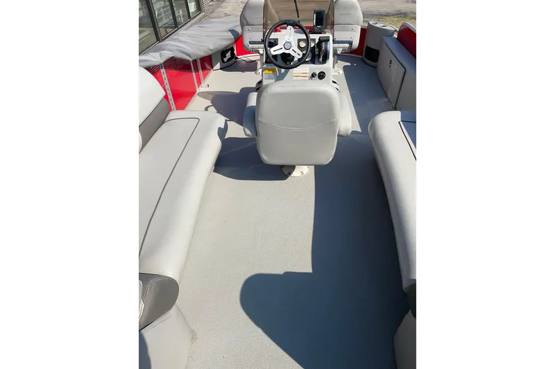 Slide: The Image of 2016 Silver Wave 230 Island CC boat interior with steering console and seating. - 10