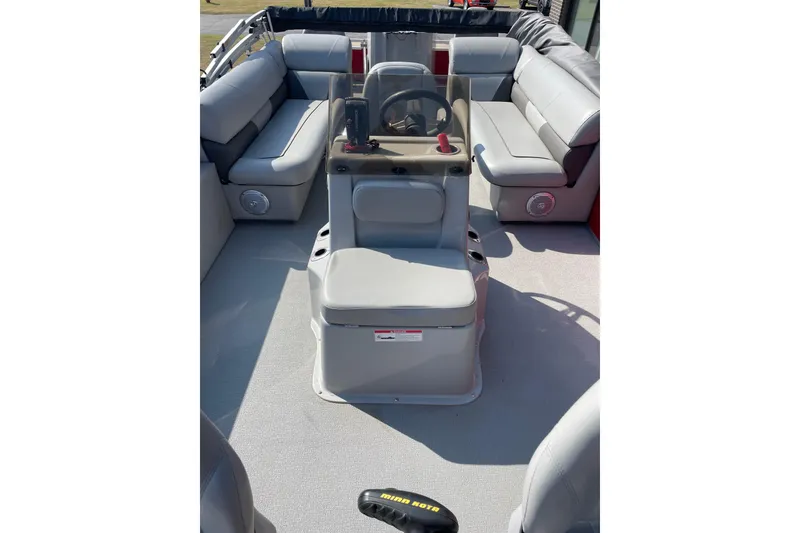 Slide: The Image of 2016 Silver Wave 230 Island CC boat interior with gray seating and steering console. - 13