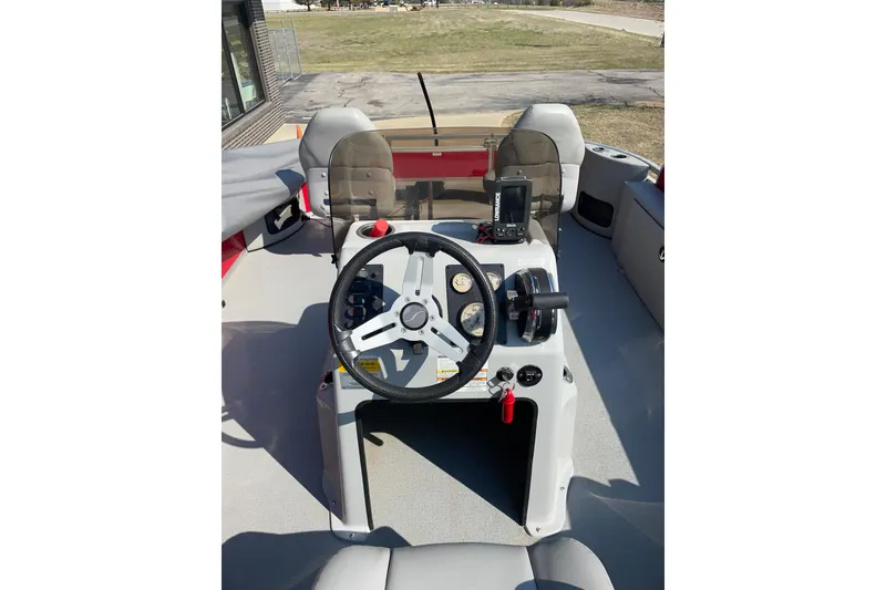 Slide: The Image of 2016 Silver Wave 230 Island CC boat dashboard with steering wheel and controls. - 14