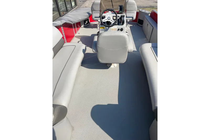 Slide: The Image of 2016 Silver Wave 230 Island CC boat interior with steering console and seating. - 2