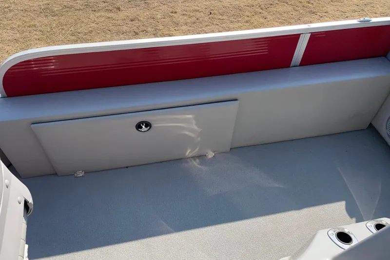 Slide: The Image of Interior view of a 2016 Silver Wave 230 Island CC boat with red and gray seating. - 4