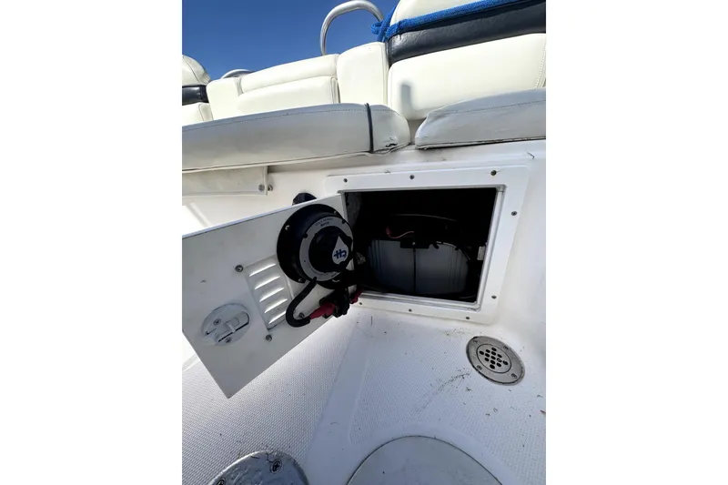 Slide: The Image of 2007 ProKat 2560 DC boat interior storage compartment with open hatch and visible wiring. - 12