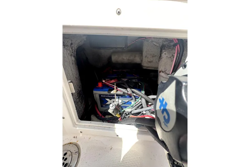 Slide: The Image of Battery compartment of a 2007 ProKat 2560 DC boat, showing wiring and connections. - 13