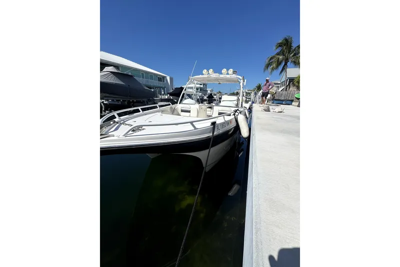Slide: The Image of 2007 ProKat 2560 DC boat docked at marina under clear blue sky. - 3