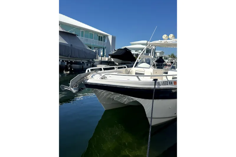 Slide: The Image of 2007 ProKat 2560 DC boat docked in a marina under clear blue skies. - 5