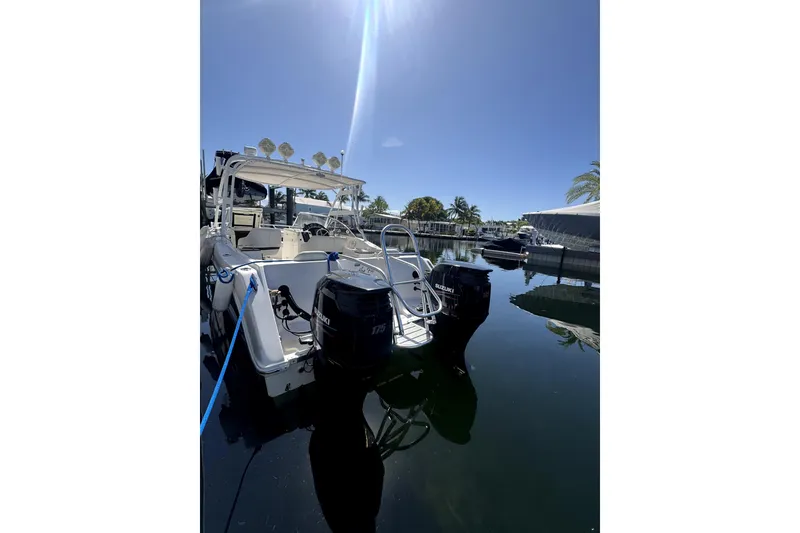 Slide: The Image of 2007 ProKat 2560 DC boat docked with dual Suzuki outboard motors. - 7
