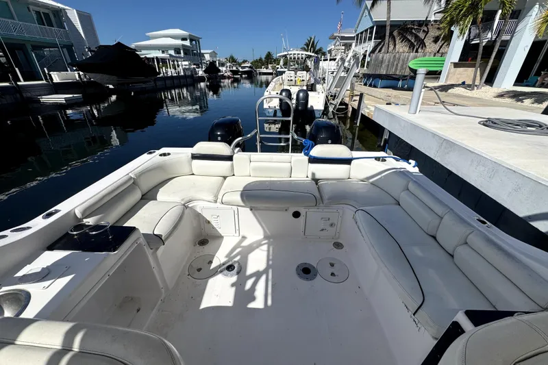 Slide: The Image of 2007 ProKat 2560 DC boat with spacious seating, docked in a serene waterfront setting. - 9