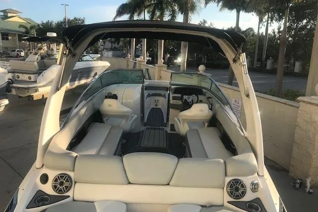 Slide: The Image of 2012 Regal 2500 Bowrider boat with spacious seating and sleek design in a marina setting. - 11