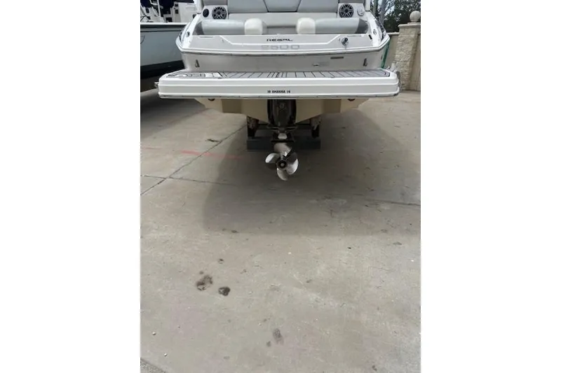 Slide: The Image of 2012 Regal 2500 Bowrider boat rear view, showcasing propeller and swim platform. - 14
