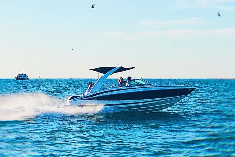 Slide: The Image of 2012 Regal 2500 Bowrider speeding on open water under clear skies. - 2