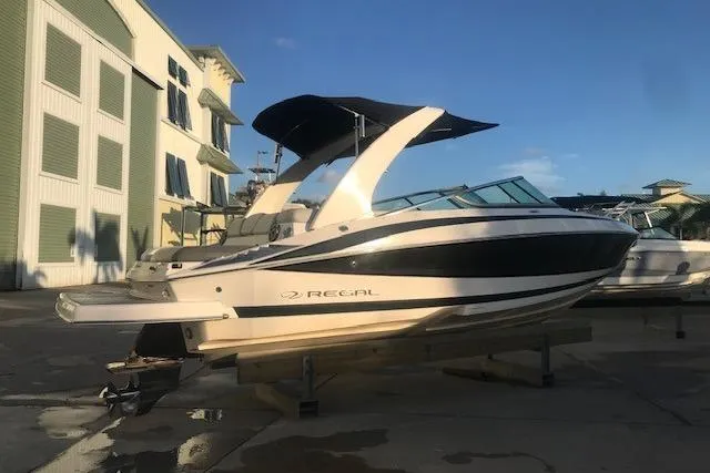 Slide: The Image of 2012 Regal 2500 Bowrider boat on display in a marina setting. - 9