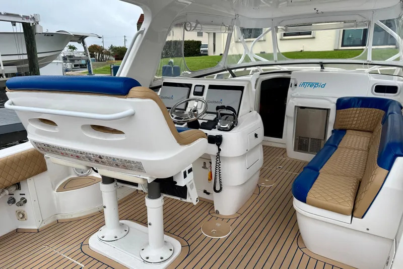 Slide: The Image of 2012 Intrepid 390 Sport Yacht cockpit with helm, seating, and navigation equipment. - 11