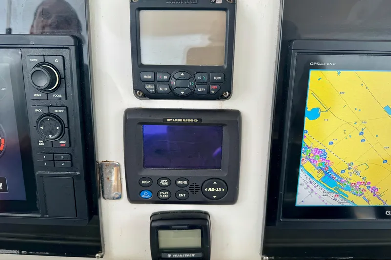 Slide: The Image of Control panel of a 2012 Intrepid 390 Sport Yacht with navigation displays. - 13