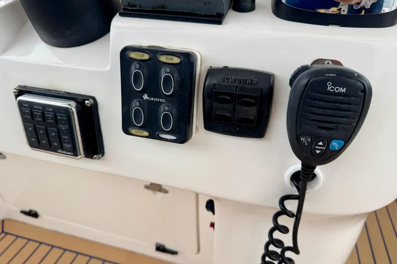 Slide: The Image of Control panel of a 2012 Intrepid 390 Sport Yacht with Icom radio and switches. - 14