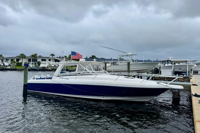 Slide: The Image of 2012 Intrepid 390 Sport Yacht docked at marina under cloudy skies. - 17