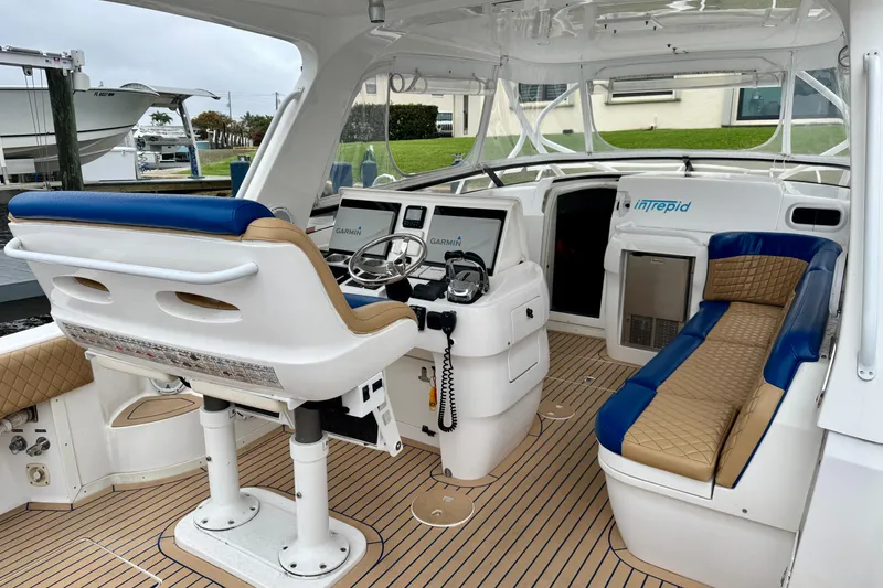 Slide: The Image of Interior of a 2012 Intrepid 390 Sport Yacht with helm and seating area. - 18