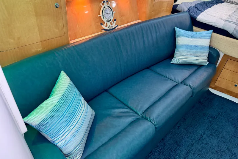 Slide: The Image of Luxurious interior of 2012 Intrepid 390 Sport Yacht with blue sofa and striped pillows. - 25