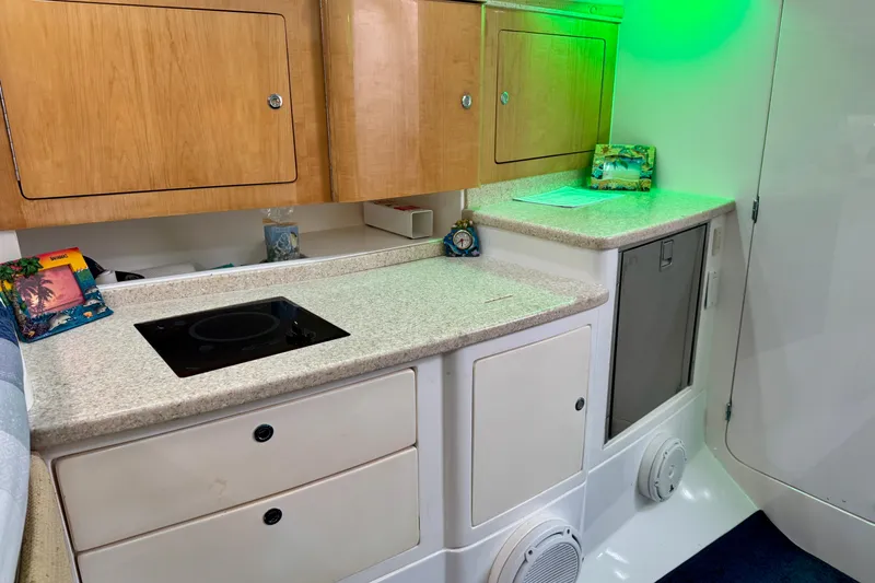 Slide: The Image of Interior of 2012 Intrepid 390 Sport Yacht kitchen with stove and cabinets. - 31