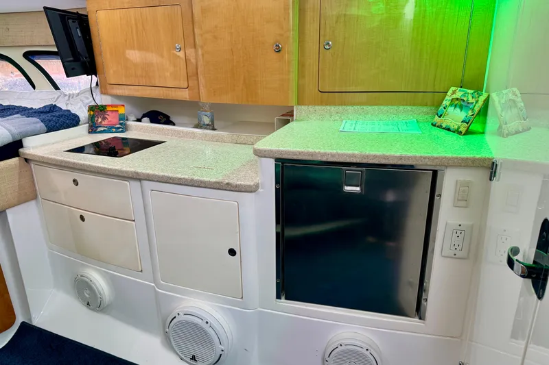 Slide: The Image of Interior of 2012 Intrepid 390 Sport Yacht with kitchenette and modern amenities. - 32