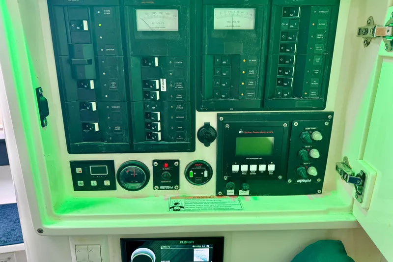 Slide: The Image of Control panel of a 2012 Intrepid 390 Sport Yacht with gauges and switches. - 33