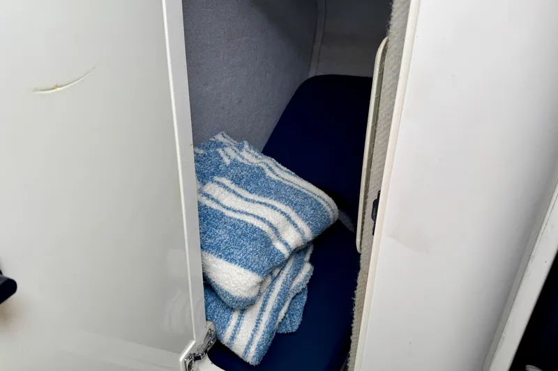 Slide: The Image of Cozy cabin interior of 2012 Intrepid 390 Sport Yacht with striped towels. - 35