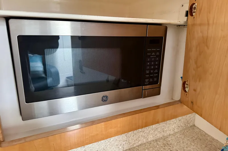 Slide: The Image of Built-in GE microwave in a 2012 Intrepid 390 Sport Yacht kitchen cabinet. - 36
