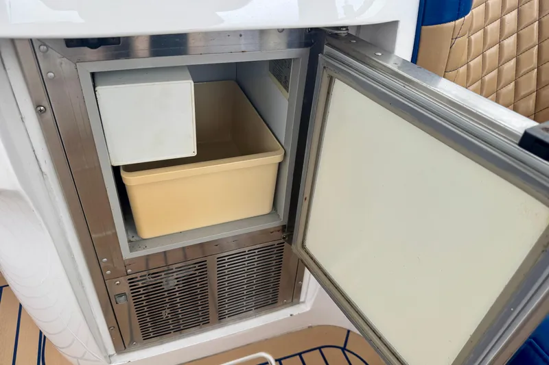 Slide: The Image of Open refrigerator on 2012 Intrepid 390 Sport Yacht, featuring a beige storage bin. - 42