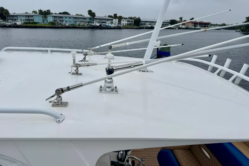 Slide: The Image of 2012 Intrepid 390 Sport Yacht with antennas on deck, docked by waterfront homes. - 45