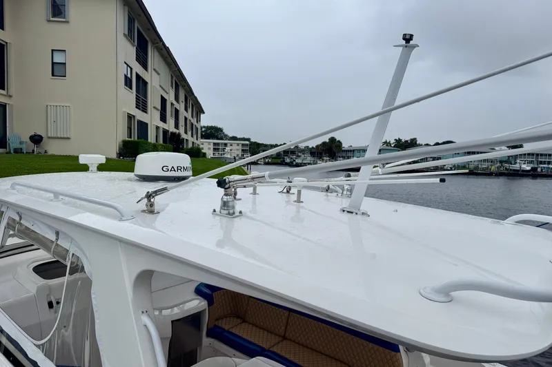 Slide: The Image of 2012 Intrepid 390 Sport Yacht with Garmin radar, docked near waterfront buildings. - 46