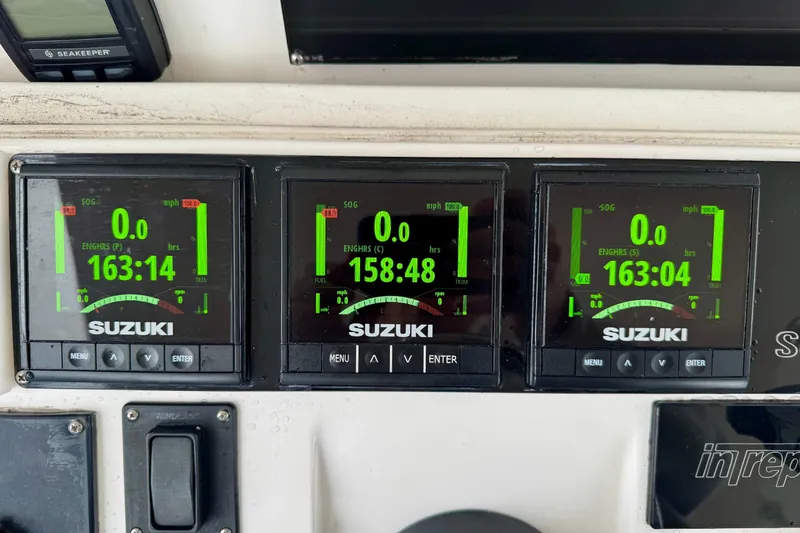 Slide: The Image of Suzuki engine displays on 2012 Intrepid 390 Sport Yacht dashboard, showing engine hours and speed. - 49