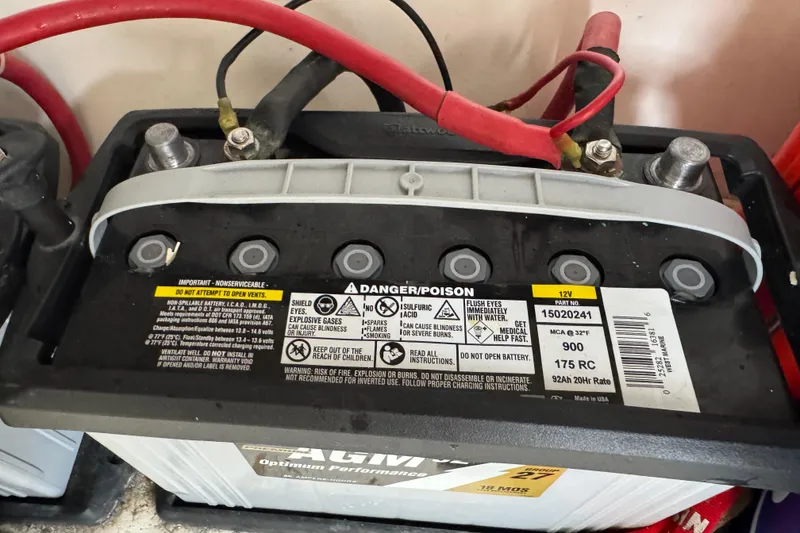 Slide: The Image of 12V AGM battery with warning labels and red cables, suitable for 2012 Intrepid 390 Sport Yacht. - 55