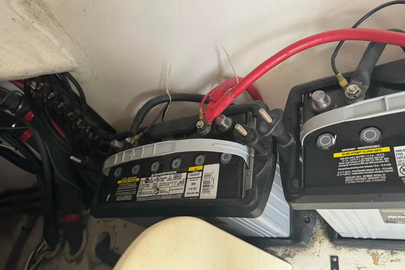 Slide: The Image of Battery compartment of a 2012 Intrepid 390 Sport Yacht with connected cables. - 56