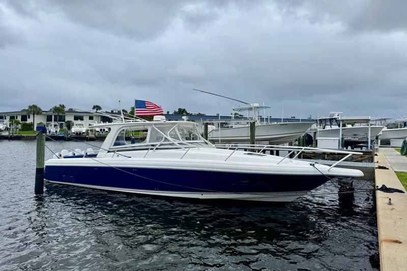 Slide: The Image of 2012 Intrepid 390 Sport Yacht docked at marina under cloudy sky. - 61
