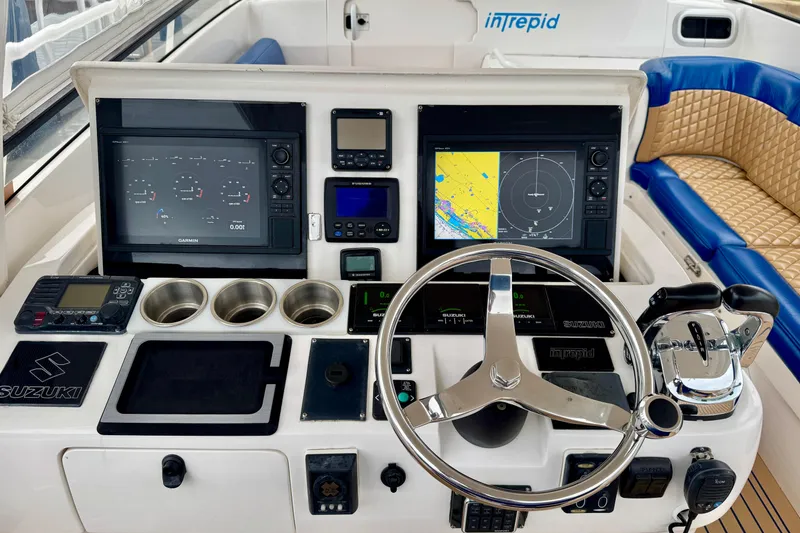 Slide: The Image of Cockpit of 2012 Intrepid 390 Sport Yacht with navigation screens and steering wheel. - 8