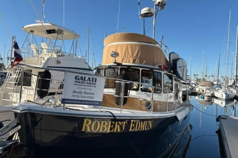 Slide: The Image of 2016 Ranger Tugs R-31 CB boat docked at marina, Galati Yacht Sales sign visible. - 2
