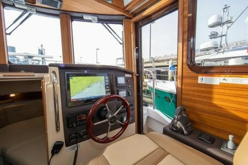 Slide: The Image of Interior of 2016 Ranger Tugs R-31 CB boat with navigation system and wooden accents. - 3