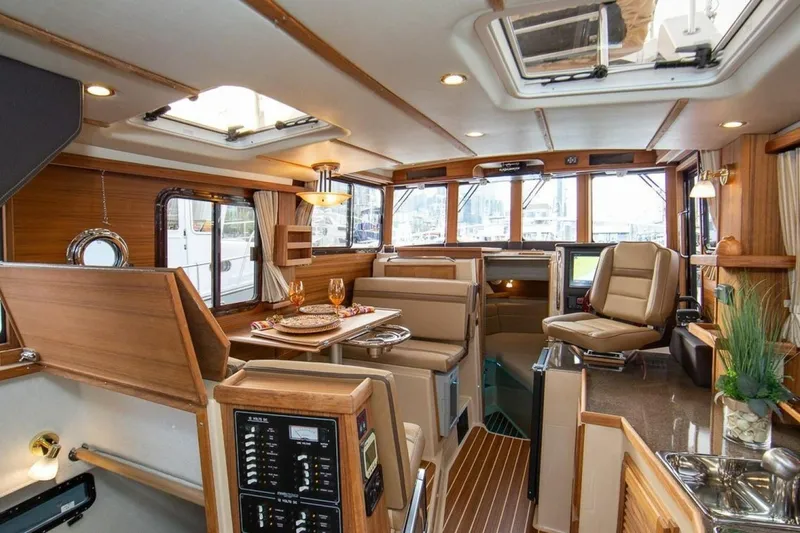 Slide: The Image of Interior of 2016 Ranger Tugs R-31 CB, featuring elegant wood finishes and modern amenities. - 5