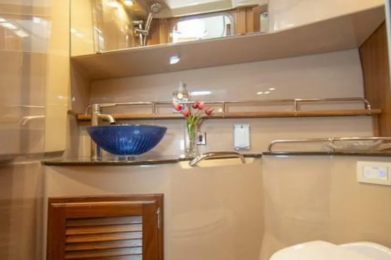 Slide: The Image of Luxurious bathroom interior of 2016 Ranger Tugs R-31 CB with blue glass sink. - 7