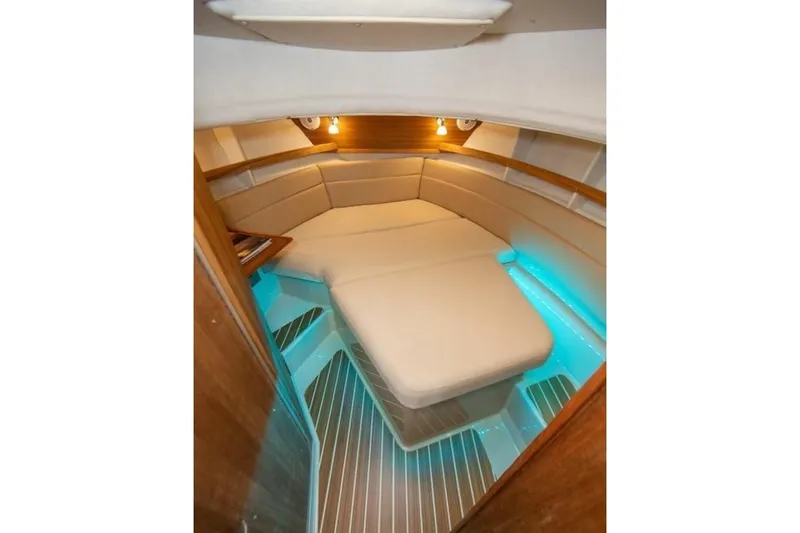 Slide: The Image of 2016 Ranger Tugs R-31 CB cabin interior with cozy seating and ambient lighting. - 9
