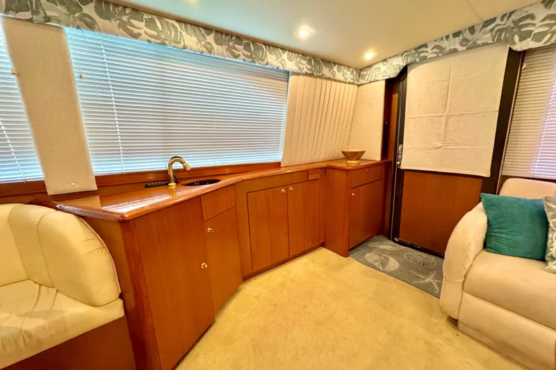 Slide: The Image of Luxurious interior of 1998 Ocean Yachts 48 Super Sport with wood cabinetry and plush seating. - 10
