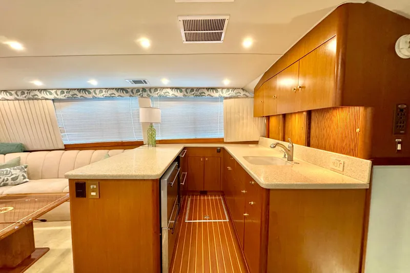 Slide: The Image of Luxurious interior of a 1998 Ocean Yachts 48 Super Sport, featuring a modern kitchen and seating area. - 11