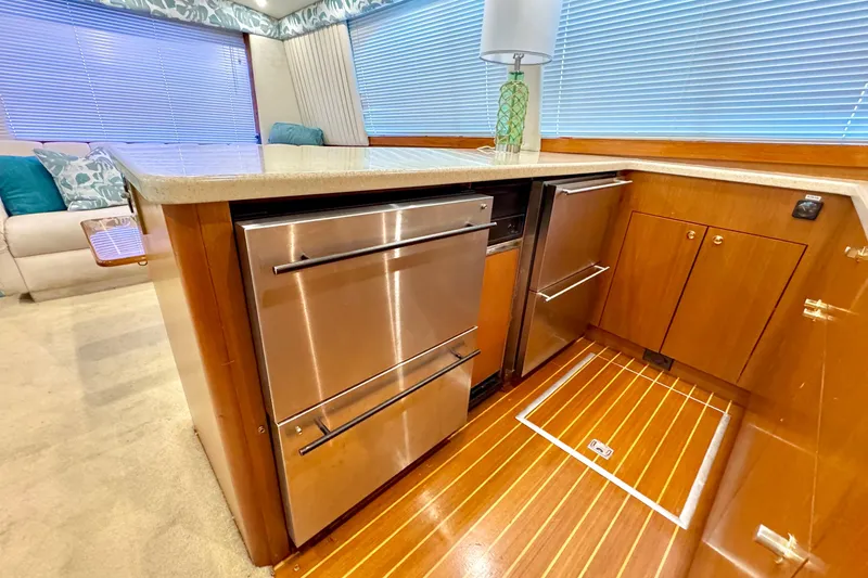 Slide: The Image of Luxurious kitchen area in a 1998 Ocean Yachts 48 Super Sport with stainless steel appliances. - 12