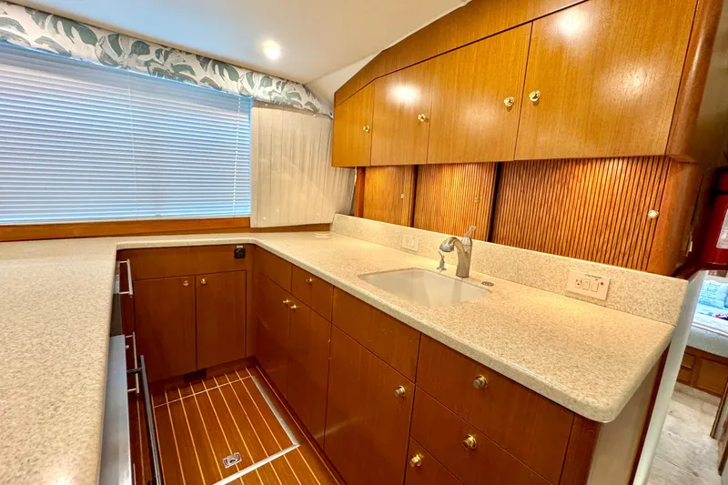 Slide: The Image of Luxurious kitchen interior of 1998 Ocean Yachts 48 Super Sport with wood cabinetry and modern fixtures. - 13
