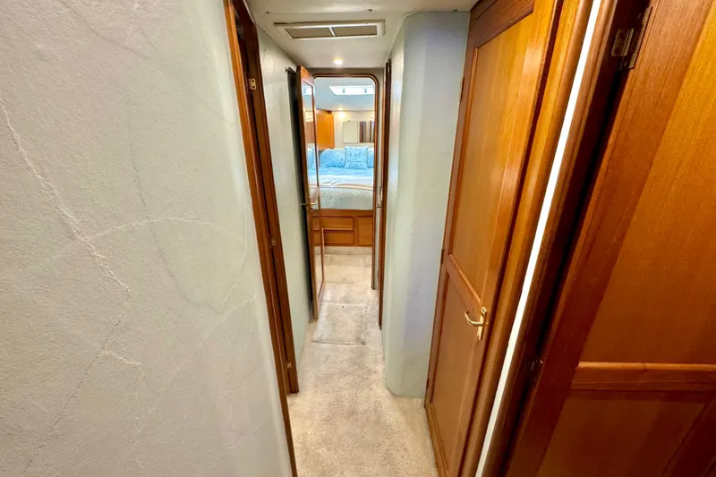 Slide: The Image of Hallway inside 1998 Ocean Yachts 48 Super Sport, featuring wooden doors and carpeted floor. - 20